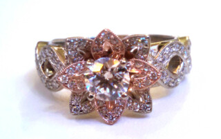 This Custom Designed Pavé Pink Petal Ring Is A Unique Engagement Ring With Round Brilliant Diamond Center And Pavé Diamonds.  The White Gold Flower Design Is Accented By Rose Gold Petals.